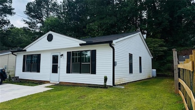 Bungalow-style home featuring fence and a front lawn