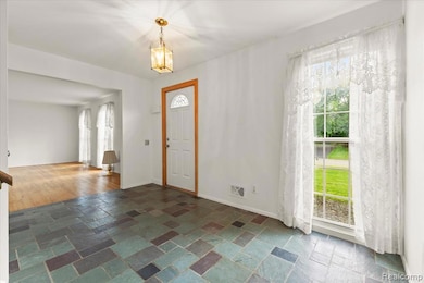 Foyer featuring stone tile floors