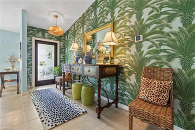 Entrance foyer featuring wallpapered walls and tile patterned flooring