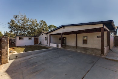 View of front of property with an outbuilding and a patio area