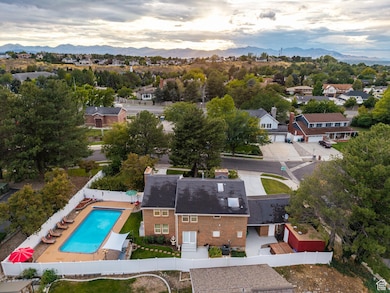 Aerial perspective of suburban area with mountains and a pool