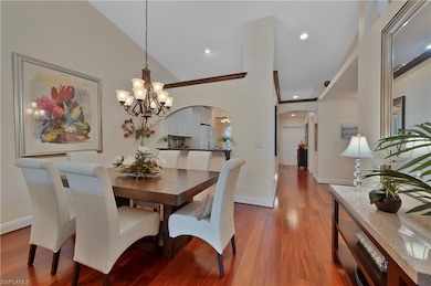 Dining space w/ wood floors, chandelier, and recessed lighting