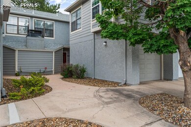 View of front facade with stucco siding, a garage, and concrete driveway