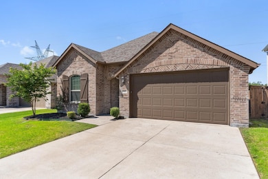 View of front of home featuring a front lawn and a garage