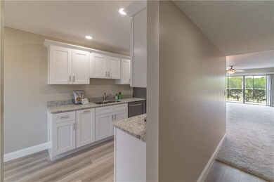Kitchen located off foyer. New laminate flooring