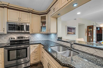 Kitchen features stainless appliances, light wood