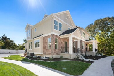 Craftsman inspired home with brick siding, a front lawn, covered porch, and board and batten siding
