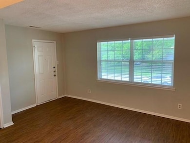Empty room featuring a textured ceiling, baseboard