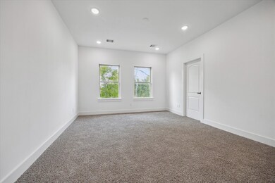 The spacious bedroom has 2 large windows for natur