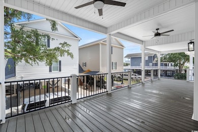 Wooden deck featuring ceiling fan