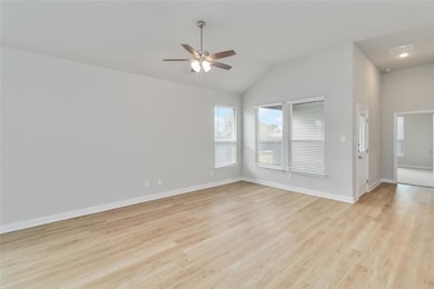 Unfurnished room featuring a ceiling fan, light w