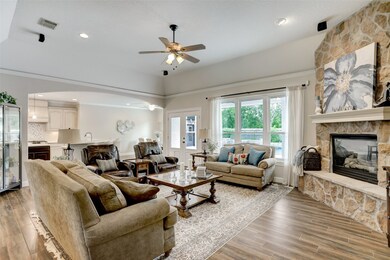 After walking through the entry hall, you arrive at the living room with its gas fireplace with stone surround.  Oversized, double pane windows allow natural light to illuminate the room and provide views of the pool and private lawn.