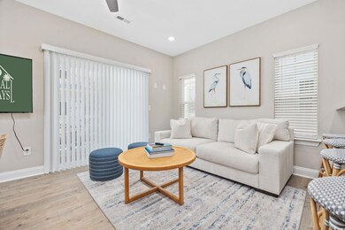 Living room featuring a ceiling fan, wood finished