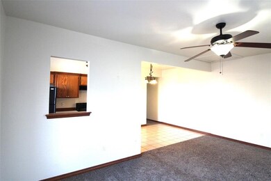 Spare room with light carpet and ceiling fan with 