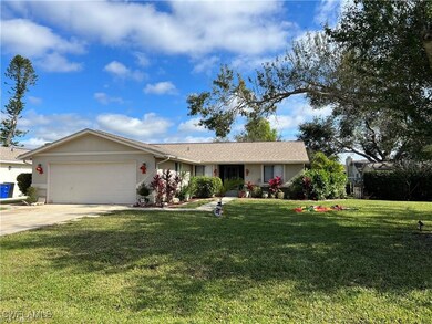 Ranch-style home with a front yard and a garage