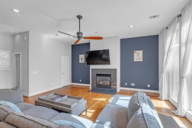 The living room includes a gas log fireplace and a