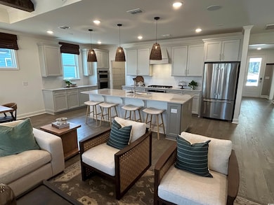 Kitchen featuring decorative light fixtures, a bre