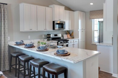 Spacious kitchen with breakfast bar, stainless app