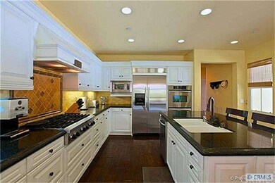 This gourmet kitchen boasts real wood flooring, gr