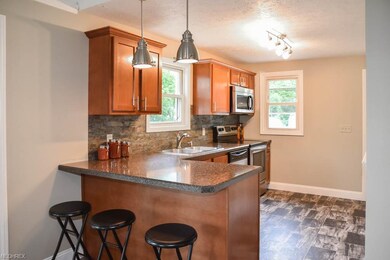 Updated kitchen with a breakfast bar and new cabin