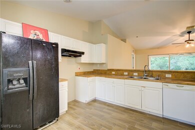 Kitchen featuring black fridge, white dishwasher,