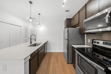 Kitchen with visible vents, a sink, tasteful back