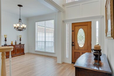 Entryway anchored by Formal Dining room