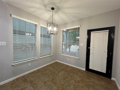 Unfurnished dining area with baseboards and a cha