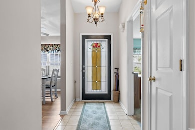 Entryway with a chandelier, plenty of natural light, and light tile patterned floors