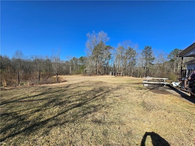 View of green lawn with a wooded view