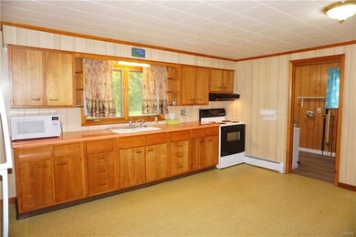 Spacious eat-in kitchen with a nice window looking out to the yard. Appliances are newer. The bathroom is through the door and there's washer & dryer hook ups in there.