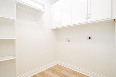 Laundry room featuring cabinets, hookup for an ele