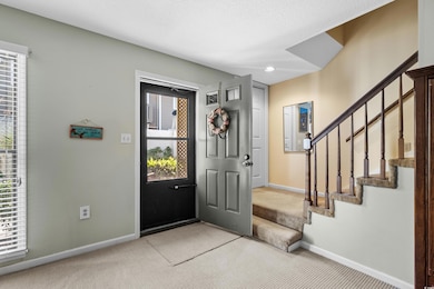 Foyer entrance with light colored carpet