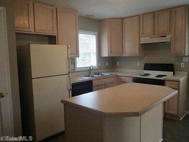 Kitchen. The kitchen features work island and opens to dining room and family room.