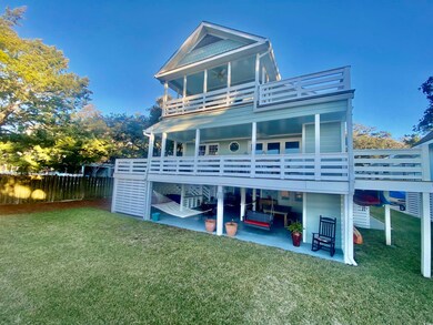 Back of property with a lawn, a patio area, and a 