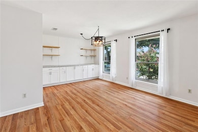 Beautiful formal living/dining or game space with built in cabinets and counter top great for serving food at parties!