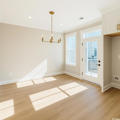 Unfurnished dining area with ornamental molding, a chandelier, light wood finished floors, and recessed lighting