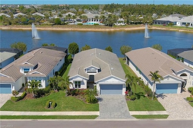 Aerial view featuring the home, a lake view and cl