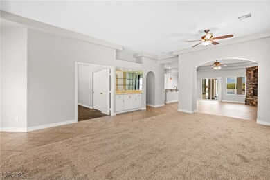 Unfurnished living room featuring a ceiling fan, a