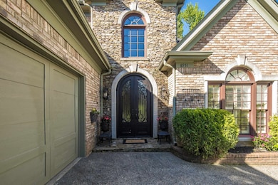 Property entrance with french doors and stone siding