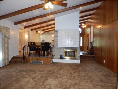 The fireplace in the living room has a floor to ce