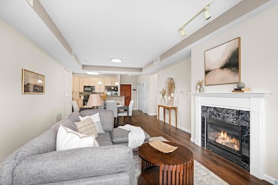Living room featuring a high end fireplace and dark wood-style floors