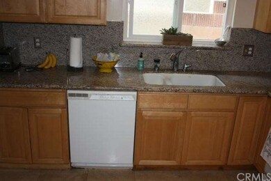 Travertine flooring compliments granite counters.