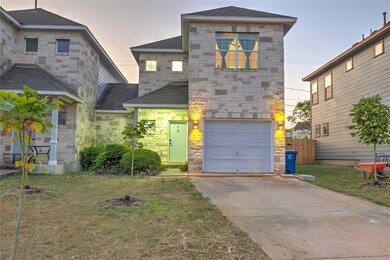 View of front of house featuring stone siding, a