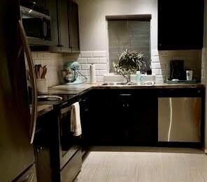 Kitchen featuring stainless steel appliances, bac