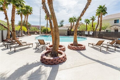 Community pool with fence and a patio area
