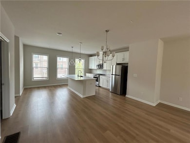 Kitchen featuring a notable chandelier, appliances
