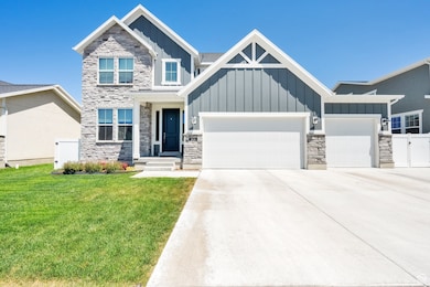 Craftsman house with board and batten siding, stone siding, an attached garage, and concrete driveway
