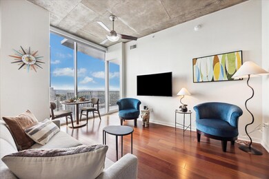 Living room featuring a wall of windows, baseboar