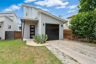 Contemporary home featuring fence, an attached ga